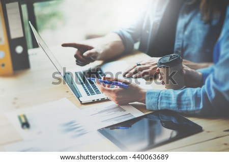 Creative team Work process modern design Studio Loft.Art director working with new freelance business startup,Using Notebook.Electronic Devices wood table. Horizontal. Film effect. Blurred background