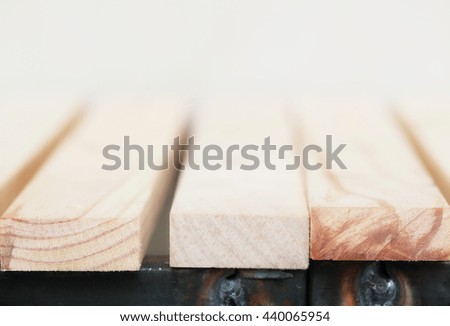 Very shallow depth of field of empty wooden table against the wall with vintage color toned. A template, a place for product display.