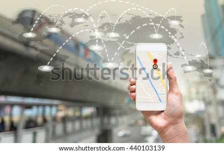 female hands holding a smart phone showing part of navigator map on connection line over the world map with blurred photo of traffic jam, Navigation concept,Elements of this image furnished by NASA
