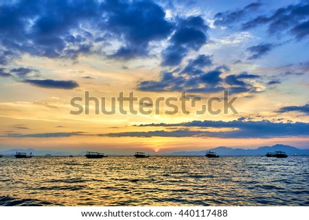 A ship sailing on the sea at dusk
