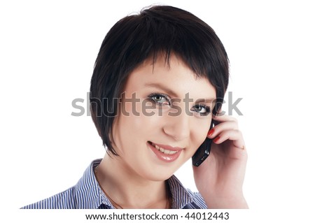 The charming brunette businesswoman in a blue shirt calls on a cellular telephone