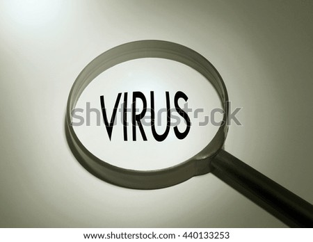 Magnifying glass with the word virus. Searching virus