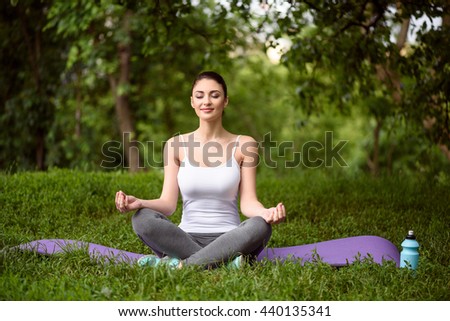Pretty girl doing yoga in the nature