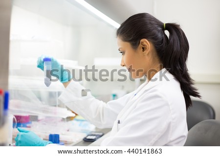 Closeup portrait, scientist holding 50 mL conical tube with blue liquid solution, laboratory experiments, isolated lab background. Forensics, genetics, microbiology, biochemistry Royalty-Free Stock Photo #440141863