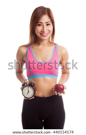 Beautiful Asian healthy girl with clock and apple  isolated on white background
