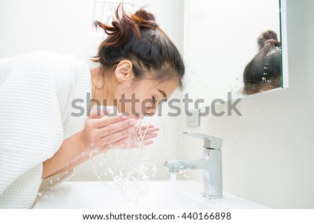 Woman wakes from sleep and she was cleansing the morning before shower Royalty-Free Stock Photo #440166898