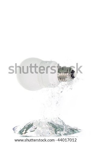 An energy saving lamp jumping out of the clear water