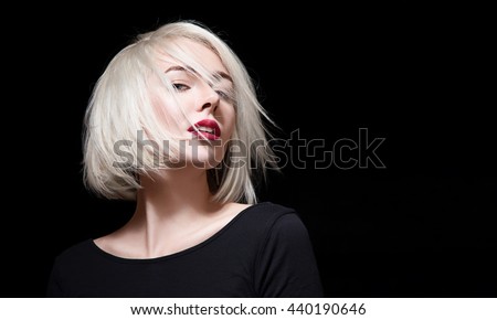 Fashionable woman with red lipstick and short hair on black background