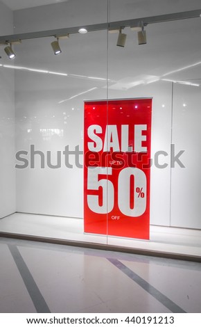 Red store discount sign on a shop window