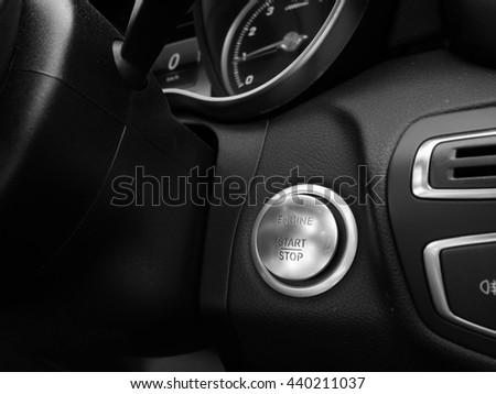 Start Stop Engine button in luxury car in black and white photography