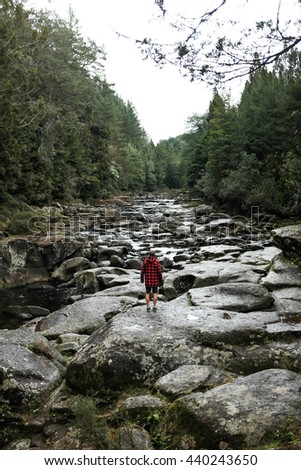 adventure traveler crossing river