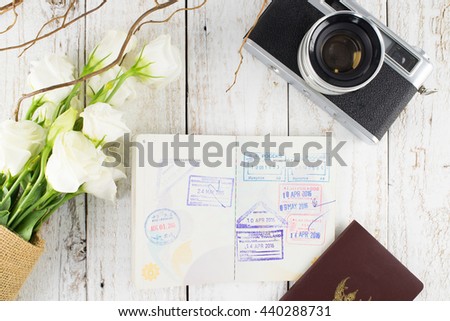 Vintage Camera, Passport and White Bouquet on White Wooden Background, Flat Lay Style, Traveler Concept