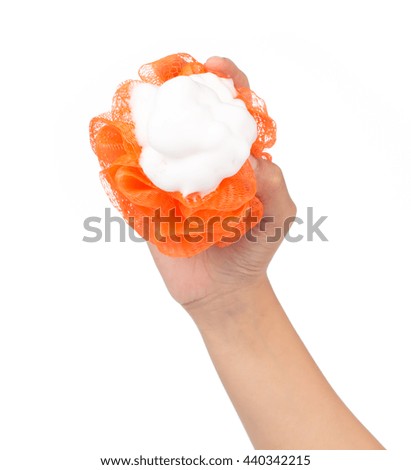 hand holding Soft orange bath puff or sponge isolated on white background