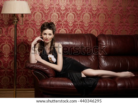 Young actress in dark interior