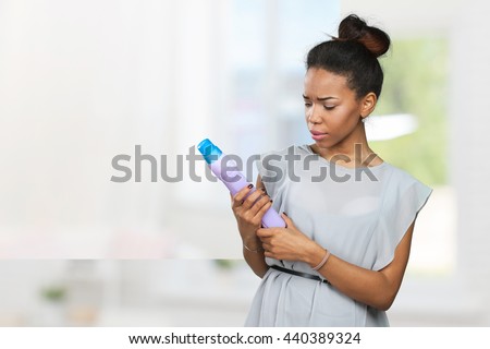 Cheerful young woman is advertising care product