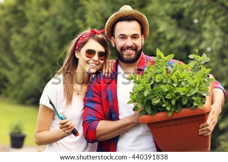 Picture of young couple working in the garden