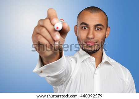 Happy successful businessman pointing on copy space