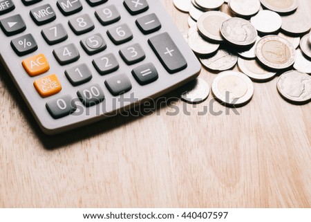 Calculator money and coins stack on chart for Finance concept