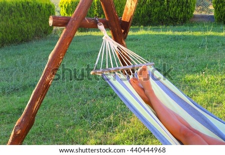 Relaxing young woman in hammock, lazy summer time, holiday vacation feeling, take a break