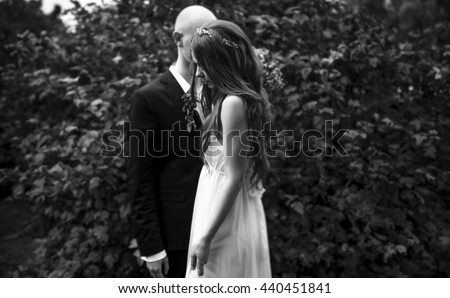 Sad picture of a wedding couple standing lonely in the forest