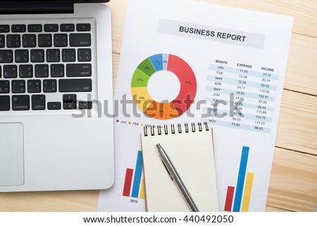 Financial report with laptop on wooden table. Accounting