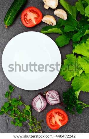 Fresh Spring Vegetables, Greens and Empty White Plate with Place for Your Text Studio Photo