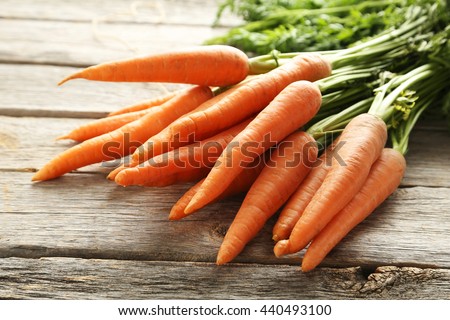 Fresh and sweet carrot on a grey wooden table Royalty-Free Stock Photo #440493100