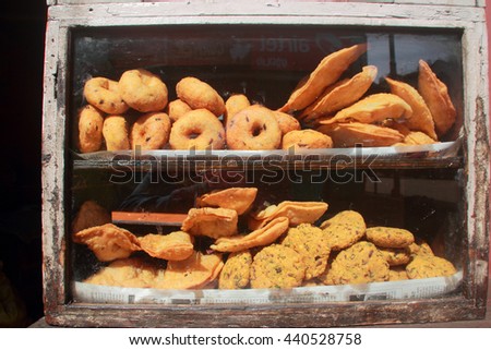 South Indian fried snacks in a shelve of a conventional food outlet