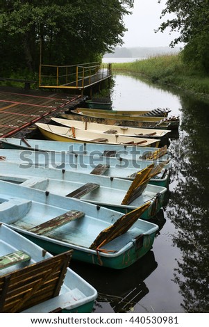 Old rowing boats on a wooden pier, a vertical picture