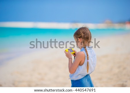 Little girl making video or photo with her camera