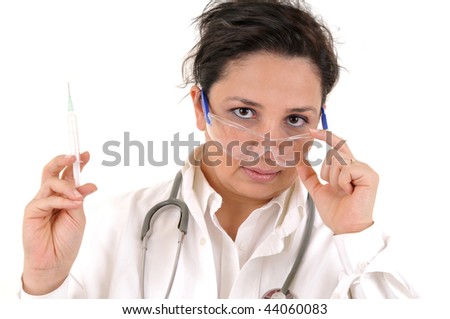 Female medical doctor with syringe looking over her glasses. White background studio picture.