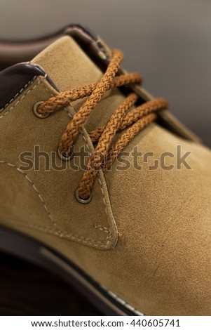 Close up shot of men's casual brown leather chukka shoes on shallow depth of field