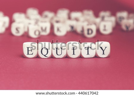 Equity word written on wood cube with red background