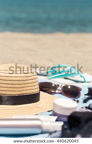 Typical beach gear of beauty products and care with female things for day in summer