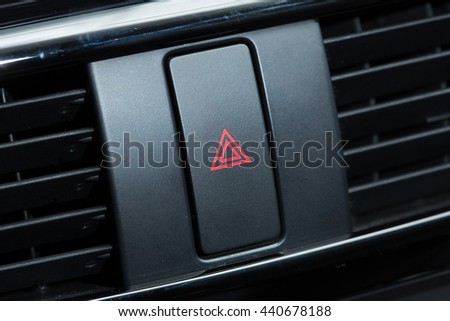 Car emergency attention light button in red triangle