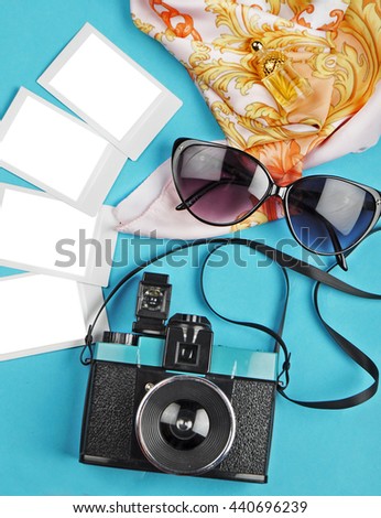 The camera and slides on the table with glasses, woman background, flat lay, travel photo. slides mockup