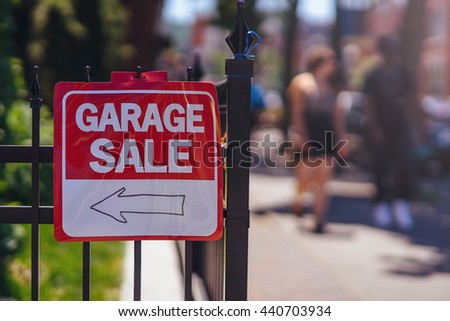 Garage Sale sign on the fence at summer day, Blurred background, flare light. Shallow DOF.