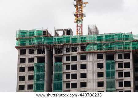 The technology or art of high rise apartment construction using crane, lift, metal beam, brick, metal ladder and concrete.