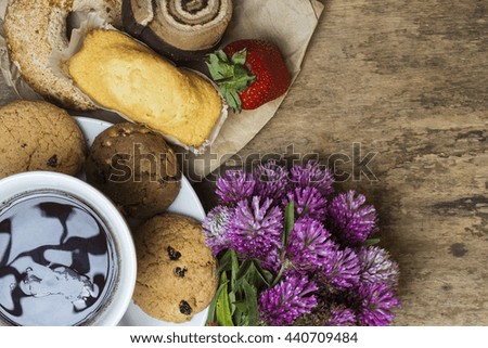 cup of coffee, decoration on old wooden table a bouquet of wildflowers, Cookies. sunny morning. space for text