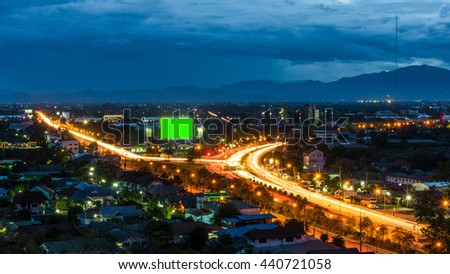 Top view of highway at night with green screen billboard 
