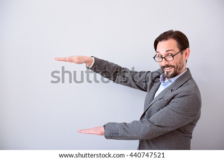 Man keeping hands like holding product