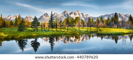 Panoramic view of Grand Teton range in Grand Teton National Park. Grand Teton National Park is in Wyoming, USA. Also, Grand Teton range is a range of mountains part of the US Rockies. Royalty-Free Stock Photo #440789620