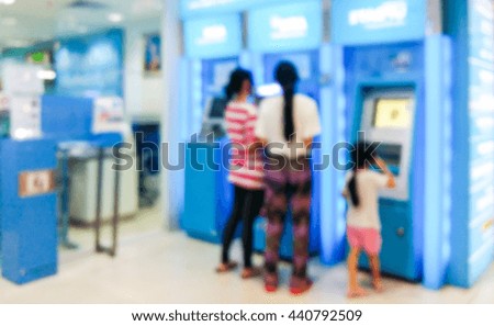 Blur image of people stand at ATM machine use for background.