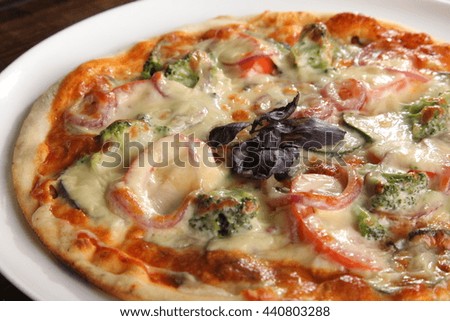 Pizza with broccoli and onions on plate