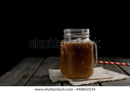 Jar of iced coffee on wooden table