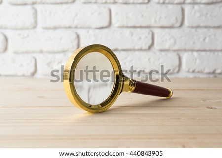 magnifying glass  on wooden table