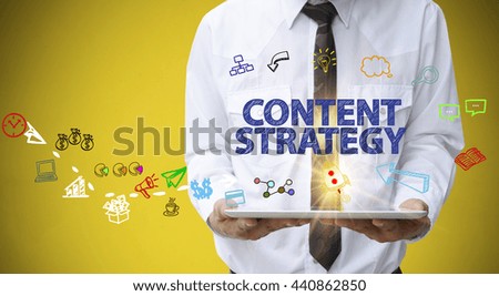businessman holding a tablet computer with CONTENT STRATEGY  text business analysis and strategy as concept