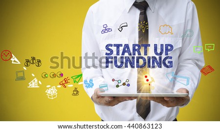 businessman holding a tablet computer with START UP FUNDING text ,business analysis and strategy as concept