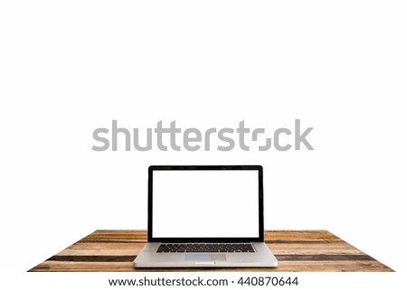 Laptop with blank screen on wooden table with white background