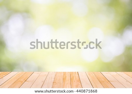 Empty wood table top on Green natural bokeh of garden